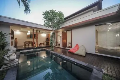 a swimming pool in the backyard of a house at Gaing Mas Jimbaran Villas by Gaing Mas Group in Jimbaran
