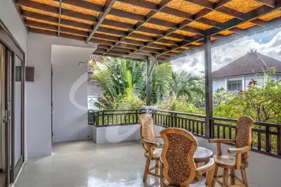 a balcony with a table and chairs and a view at Vila Ultima Bali in Seminyak