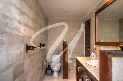 a bathroom with a toilet and a sink at Vila Ultima Bali in Seminyak