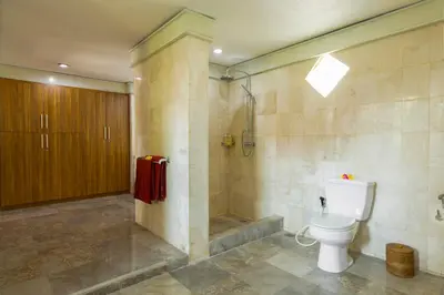 a bathroom with a toilet and a shower at Villa Kibbi in Seminyak