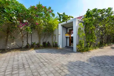 a house with trees and a brick driveway at Villa Kibbi in Seminyak