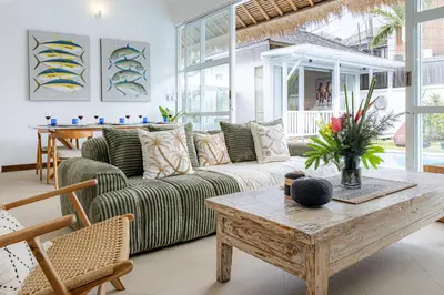 a living room with a couch and a table at Villa Blue Pearl by Optimum Bali Villas in Seminyak