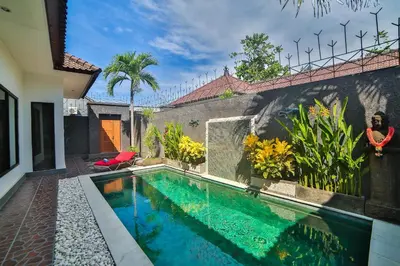 a swimming pool in the backyard of a house at Bali Cinta Villa in Seminyak