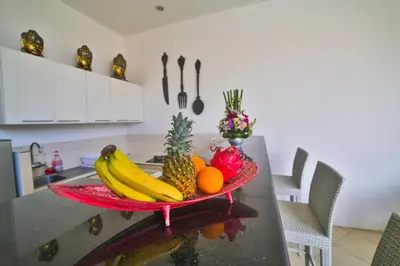 a plate of fruit on a counter in a kitchen at Bali Cinta Villa in Seminyak