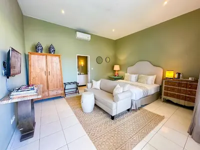 a living room with a couch and a bed at Room Sweet Room - Seminyak Center, walk to the Beach in Seminyak