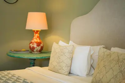 a bedroom with a bed with a table with a lamp at Room Sweet Room - Seminyak Center, walk to the Beach in Seminyak