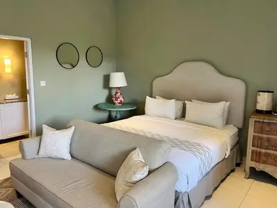 a bedroom with a large bed and a couch at Room Sweet Room - Seminyak Center, walk to the Beach in Seminyak