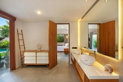 a bathroom with two sinks and a large mirror at Villa Odyssey in Seminyak