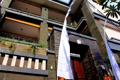 a white flag hanging from the side of a building at Pondok 3 Mertha in Kuta