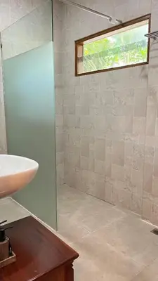 a bathroom with a sink and a window at Baliana Villa Legian in Legian