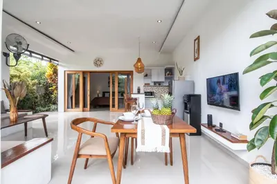 a dining room and living room with a table and chairs at Adorable 1BR villas in the heart of Seminyak in Seminyak