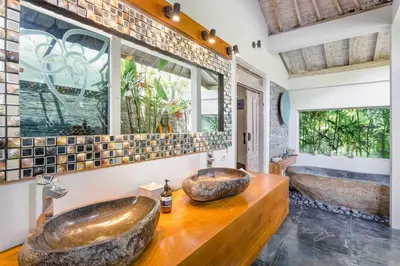 a bathroom with two sinks on a wooden counter at Villa Cinta Damai - Stunning & Stylish 4BR Luxury Villa in the Heart of Seminyak, Just a 10-Min Walk to the Beach in Seminyak