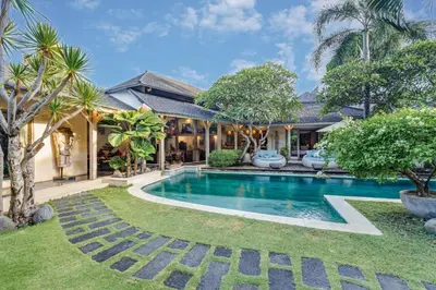 a swimming pool in the yard of a house at Villa Cinta Damai - Stunning & Stylish 4BR Luxury Villa in the Heart of Seminyak, Just a 10-Min Walk to the Beach in Seminyak