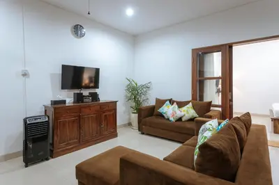 a living room with a couch and a flat screen tv at Villa Sedana, Seminyak - 2 Bedroom Private Pool Villa! in Seminyak