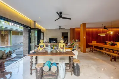 a living room with a table and a dining room at Jadine Bali Villa by Nagisa Bali in Canggu