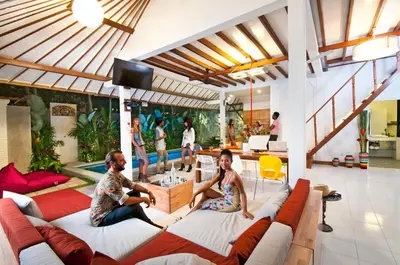 a man and woman sitting on couches in a living room at 3BR Villa Hari - Special Stay Bonus - Minggu Villas Seminyak in Seminyak