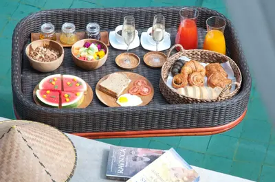 a table with a tray of breakfast foods and drinks at 3BR Villa Hari - Special Stay Bonus - Minggu Villas Seminyak in Seminyak