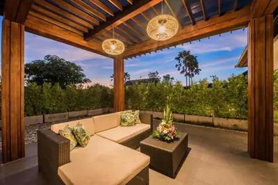 a patio with a couch and chairs and a table at Villa Sally in Canggu