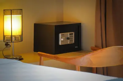 a bedroom with a tv on a table with a chair at The Murdha Villa in Seminyak