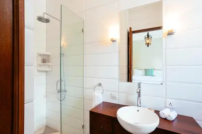a bathroom with a sink and a shower at Villa Mandala in Seminyak