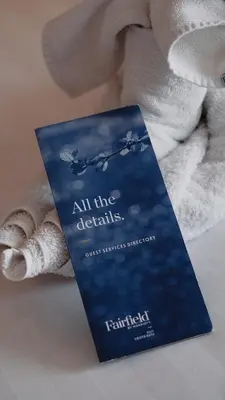 a book sitting on top of a towel at Fairfield by Marriott Bali South Kuta in Kuta