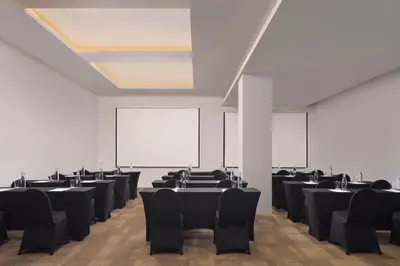 a room with rows of tables and chairs at Fairfield by Marriott Bali South Kuta in Kuta