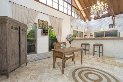 a living room with a table and a counter at Ocean Star 5 in Seminyak