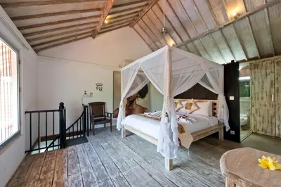 a bedroom with a bed with a canopy at Grange Villa - Legian in Legian