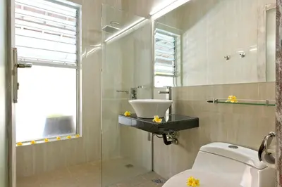a bathroom with a sink and a toilet at Grange Villa - Legian in Legian
