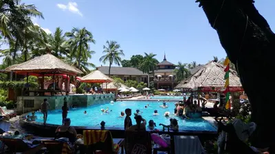 a group of people in a swimming pool at a resort at Private Apartments at Jayakarta Resort in Legian