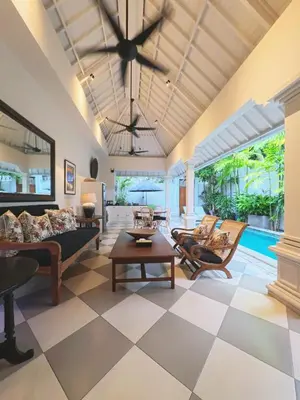 a living room with a couch and a table at Villa Antiga 2 in Seminyak