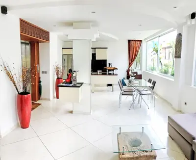 a living room with a couch and a table at Flora Apartment Bali in Seminyak