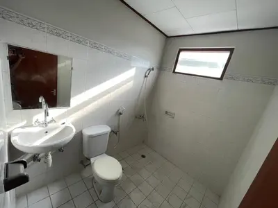 a bathroom with a toilet and a sink at Palm Garden Kuta in Kuta