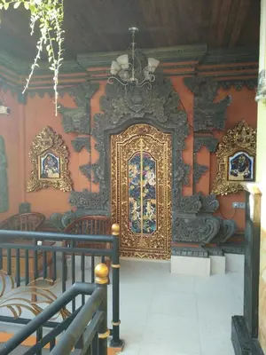 a room with a gold door on a wall at Asta House in Kuta