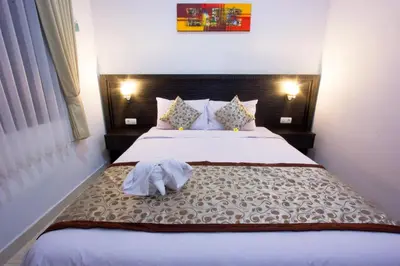 a bedroom with a large bed in a room at Asta House in Kuta