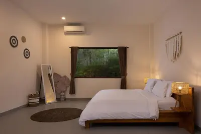 a bedroom with a white bed and a window at Villa Destino - Seminyak Bali in Seminyak