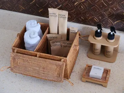 a basket with towels and other items on a counter at Mövenpick Resort & Spa Jimbaran Bali in Jimbaran