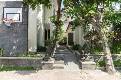 a basketball hoop on the side of a house with trees at Legian Village Beach Resort - CHSE Certified in Legian