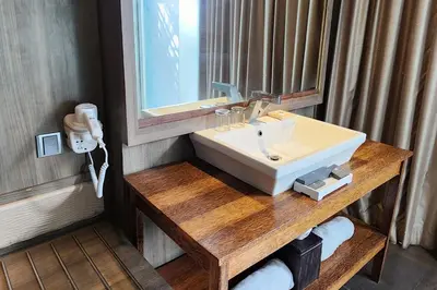 a bathroom with a white sink and a mirror at The Crystal Luxury Bay Resort Nusa Dua in Nusa Dua