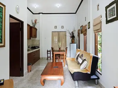 a living room with a couch and a table at Rumah Akira Seminyak in Seminyak