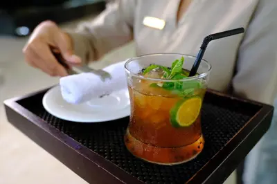 a drink sitting on a tray with a plate at The Sintesa Residence Jimbaran in Jimbaran