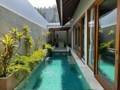 a swimming pool in the middle of a house at Sithala Villa Seminyak in Seminyak