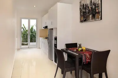 a kitchen and dining room with a table and chairs at Villa Lamac in Legian