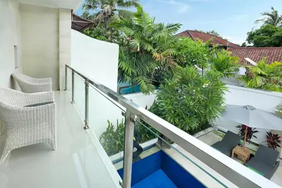 a balcony with a view of trees and plants at Villa Lamac in Legian