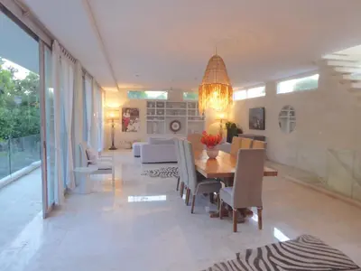 a dining room with a table and chairs at Bali Villa Beachfront Luxe Rooftop Sunsets in Canggu