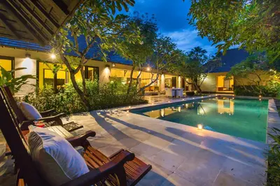 a swimming pool in the backyard of a house at Villa Roku by Nagisa Bali in Seminyak