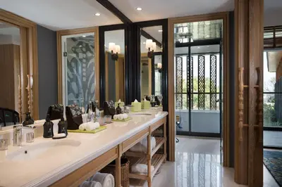 a bathroom with two sinks and a large mirror at Hotel Indigo Bali Seminyak Beach by IHG in Seminyak