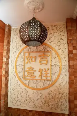 a chandelier and a sign on a wall at Seahouse Bali Indah Beach Inn in Kuta