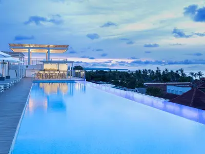 a swimming pool on the roof of a building at Holiday Inn Express Baruna by IHG in Kuta