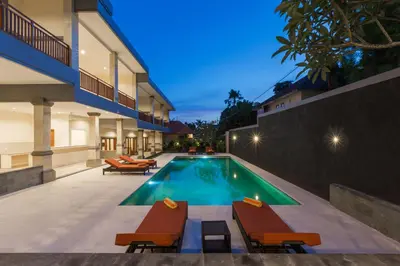 a swimming pool in the backyard of a house at Kubu Petitenget Suite Seminyak in Seminyak